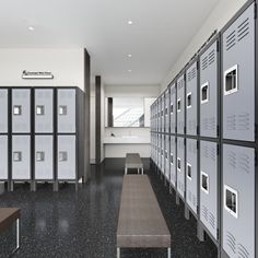 lockers are lined up against the wall with benches