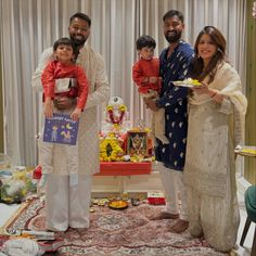 a family poses for a photo in front of a table with food and decorations on it