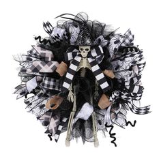 a skeleton wreath with black and white decorations