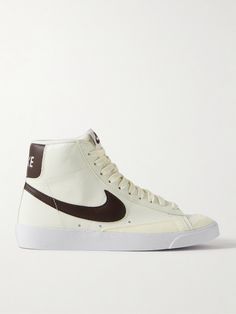 Nike's 'Blazer Mid '77' high-top sneakers date back nearly five decades, and clearly have lasting appeal, as they're still so cool today. This pair is made from crinkled-nubuck in a brown and cream colorway and has suede trimming the toes. The padded collar ensures a comfortable fit. Nike Blazer Mid 77 Brown, Brown Nike Blazers, Mid 77 Blazer Outfit, Nike Blazer Mid 77 Colors, Mid 77 Blazer, Twin Outfit, Blazer Mid 77 Vintage, High Tops Women, Blazer Outfits For Women