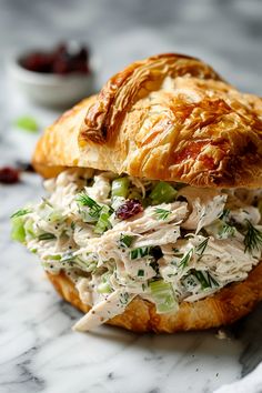 a croissant sandwich with chicken salad on it