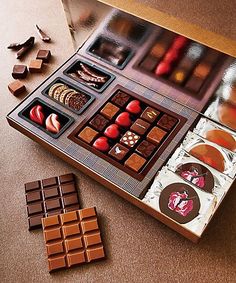 an assortment of chocolates in a box on a table with pieces of the same type