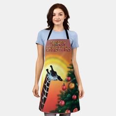 a women's apron with a giraffe and christmas tree on the front