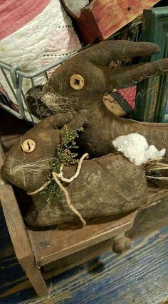 an old stuffed animal sitting on top of a wooden crate