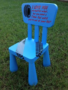 a blue plastic chair sitting in the grass