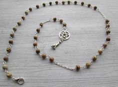 a rosary with a pen and cross on it