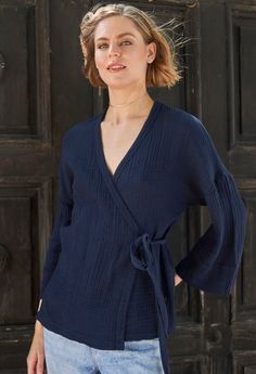 Eco friendly caftans and tunics inspired by the ocean, made on main street. Ethically sourced and locally made in Los Angeles. Our super soft, easy-care cotton gauze fabric gets a glamorous upgrade in our flattering kimono sleeve wrap top. With a self belt, this one allows you to choose your look. Tie it loose for an elegant drapy top or wrap it around your waist to accentuate your shape. The relaxed kimono sleeves are just the right bracelet length and can be easily folded back for a more dramatic look. Pairs perfectly with our gauze palazzo pant and just about everything else in your wardrobe. Sheerness: none Model height: 5'10" Fabric: 100% Cotton Machine wash, tumble, hang or lay flat to dry. Kimono Wrap Top, Caftan Tunic, Kimono Blouse, Cotton Gauze Fabric, Palazzo Pant, Kimono Wrap, Kimono Sleeves, By The Ocean, Dramatic Look