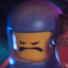 the lego movie character is wearing a helmet