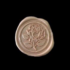 a wax stamp with a rose on it