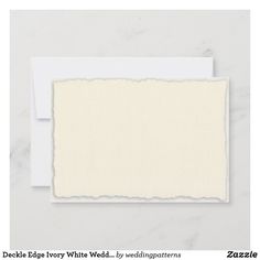 a piece of paper with torn edges on a white background next to a blank card