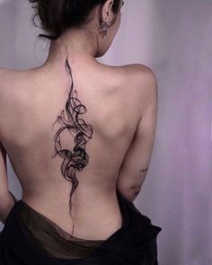 a woman with a tattoo on her back