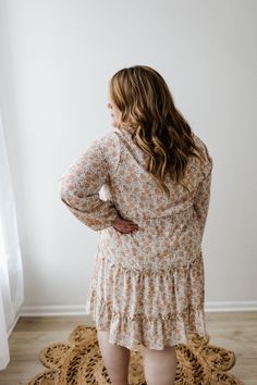 This beautiful neutral midi-length dress has all of the boho vibes! It is going to be your new go-to for date nights, weddings, and work events. This dress features a modest, shorter v-neckline and fluttery blouson long-sleeves. The blousy material flows beautifully down the dress's skirt, with the bottom featuring a tiered effect edged by ruffles. The smocked waist gives the dress an a-line fit that will accentuate your curves beautifully and provide structure to this extra flowy dress. The lin