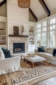 a living room filled with furniture and a fire place in the middle of a room