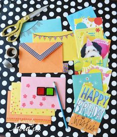 a table topped with lots of different types of greeting cards and paper work on top of each other