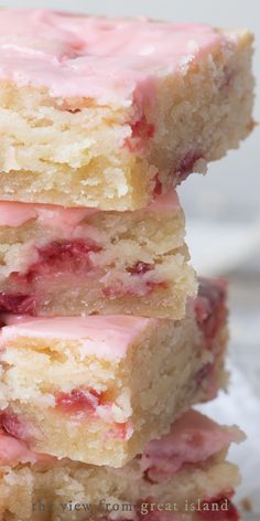 three pieces of strawberry shortbread stacked on top of each other with pink icing