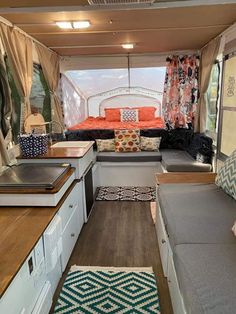 the inside of a camper with couches and kitchenette in it's center