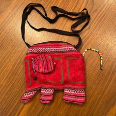 Darling Red Cloth Elephant Shaped Bag With Colorful Beaded Tail And Beads Around Ears. Zipper Opening And Black Cotton Interior. Black Fabric Strap. Elephant Is 6”X9”. Strap Is 20” Long. Never Used. Red Beaded Bag As Gift, Red Beaded Bag For Gift, Red Beaded Rectangular Shoulder Bag, Everyday Red Beaded Bags, Traditional Red Beaded Bags, Bohemian Red Beaded Shoulder Bag, Red Bohemian Beaded Shoulder Bag, Red Festival Bag With Adjustable Strap, Red Bags With Adjustable Strap For Festival