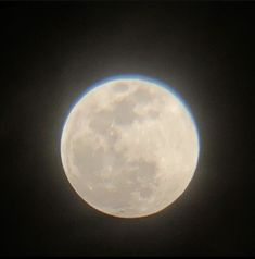 the full moon is visible in the dark sky