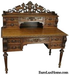 an old wooden desk with ornate carvings on the top and bottom drawer, sitting in front of a white background