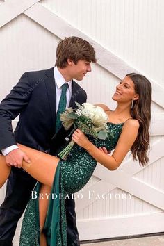 a man in a suit and tie is hugging a woman wearing a green sequined dress