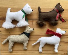 four different types of dogs on a wooden surface