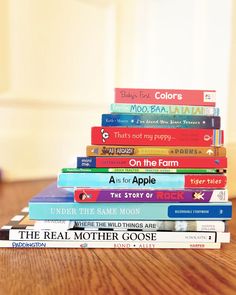 a stack of books sitting on top of a wooden table