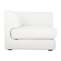 a white couch sitting on top of a wooden table