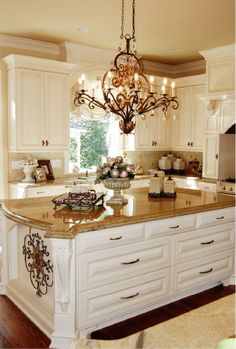 a large kitchen with an island and chandelier