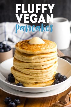 fluffy vegan pancakes on a plate with blueberries and syrup in the background text reads, fluffy vegan pancakes