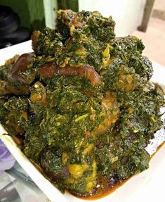 a white plate topped with greens and meat