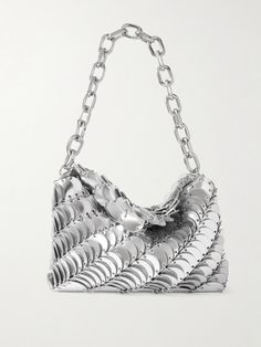 Interpreting archival chainmail styles, Rabanne's shoulder bag is handcrafted from metallic leather discs linked together with silver-tone hardware. It's set on an industrial-style chain and slopes gently, creating a slouchy profile. Silver Metal Chain Link Bag, Luxury Silver Shoulder Bag With Chain, Silver Metal Chainmail Bag, Silver Chainmail Evening Bag, Flat Dress Shoes, Floral Dresses Short, Fine Jewelry Designers, Paco Rabanne, Beauty Accessories