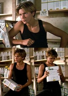 the young man is sitting in front of books