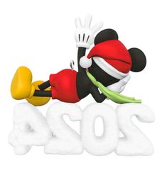 the mickey mouse is laying on top of the year sign with his arms and legs spread out