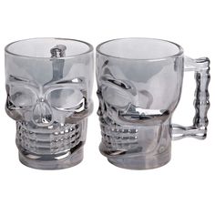 two glass mugs that have been designed to look like skull heads and are sitting side by side