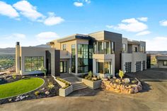 a large house with lots of windows and landscaping