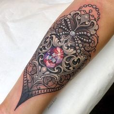 a woman's arm with a tattoo on it and an ornate design in the middle