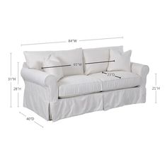 a white couch with four pillows and measurements