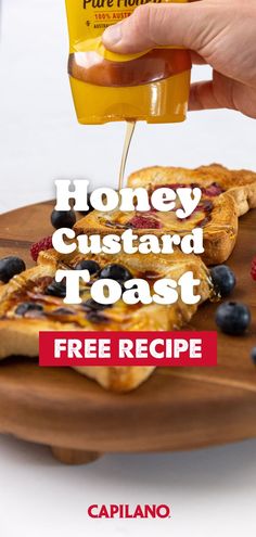 honey custard toast with blueberries and raspberries is being poured onto a plate