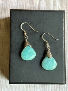 "Handmade wire wrapped Larimar suspended from .925 sterling silver French ear wires.  These earrings have been hand wire wrapped with sterling silver 26 gauge wire.  Earring Measurements:  1 1/2\" long by 1/2\" wide.  The stone is natural Larimar,  which is only found in the Dominican Republic.  Another name for the stone is called the Atlantis stone for its striking aqua blues reminiscent of the Caribbean sea and the lost city of Atlantis. Larimar is a rare form of Blue Pectolite. If you would Amazonite Natural Stone Earrings For Gifts, Amazonite Drop Earrings As Gift, Silver Larimar Dangle Earrings, Dangle Earrings With Amazonite And Natural Stones, Handmade Turquoise Amazonite Earrings, Handmade Dangle Amazonite Earrings, Handmade Amazonite Dangle Earrings, Hypoallergenic Amazonite Jewelry As Gift, Larimar Dangle Earrings For Gifts