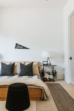 a bedroom with white walls and black accents