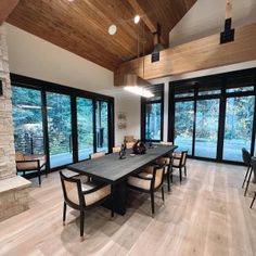 a large dining room with wood floors and windows