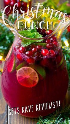 a pitcher filled with cranberry punch on top of a wooden table