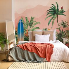 a bedroom with a surfboard painted on the wall and palm trees in the background