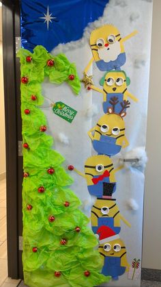 a door decorated to look like a christmas tree with minions on it and decorations around the bottom