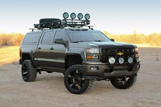 a truck with four lights is parked in the dirt