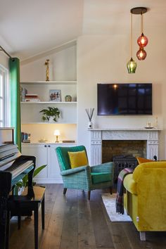 a living room filled with furniture and a flat screen tv mounted above a fire place