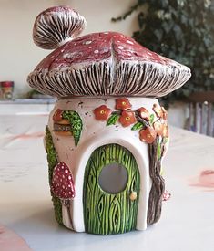 a ceramic mushroom house sitting on top of a table