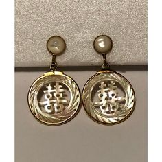 This is a lovely pair Vintage Japanese Mother of Pearl Dangle Earrings that will look amazing day and night. The round abalone post part of the earrings is surrounded by a gold-filled, beaded outer-ring as is the handcarved, dangle part of the earrings that has Japanese wording carved out. These screw back Asian-inspired earrings are really quite feminine, reflect the light beautifully and will be a nice addition to your vintage jewelry collection.  Condition: Excellent vintage condition; please see pics for details. Marks: none Dimensions: approximately 1"W x 1.75"L Yellow Gold Mother Of Pearl Earrings, Elegant Medallion Earrings For Gift, Elegant Nickel-free Medallion Earrings, Yellow Gold Mother Of Pearl Round Earrings, Pierced Round Mother Of Pearl Jewelry, Formal Mother Of Pearl Round Earrings, Gold Round Earrings With Mother Of Pearl, Anniversary Mother Of Pearl Round Earrings, Gold Mother Of Pearl Round Earrings