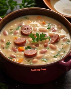 a bowl of soup with sausages and beans