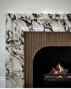 a fire place with a marble fireplace surround